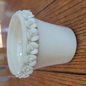 Vintage small planter pot in creamy white with a floral pattern around the top.